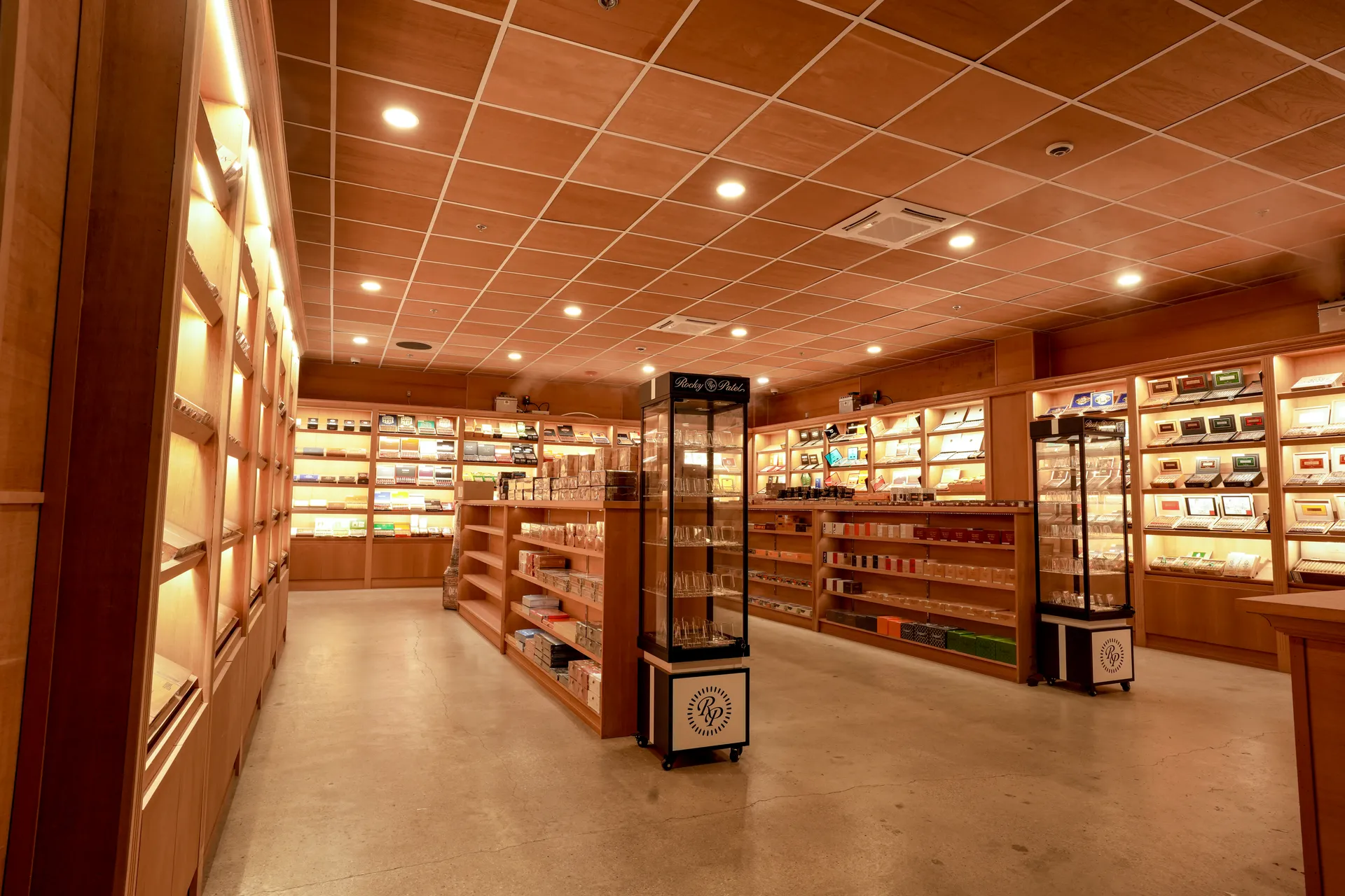 The 1,100 square foot walk-in humidor with Spanish cedar shelving and a Rocky Patel display at Single Malt Cigar Bar